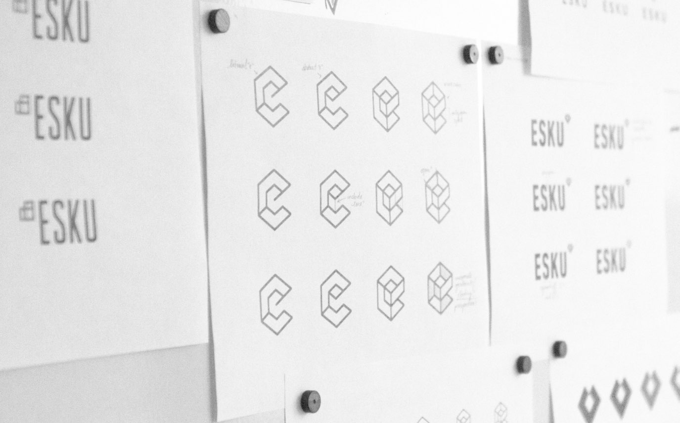 Esku logo sketches on whiteboard